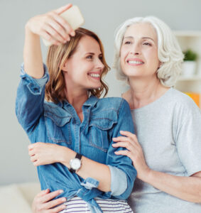 mother and daughter take selfie